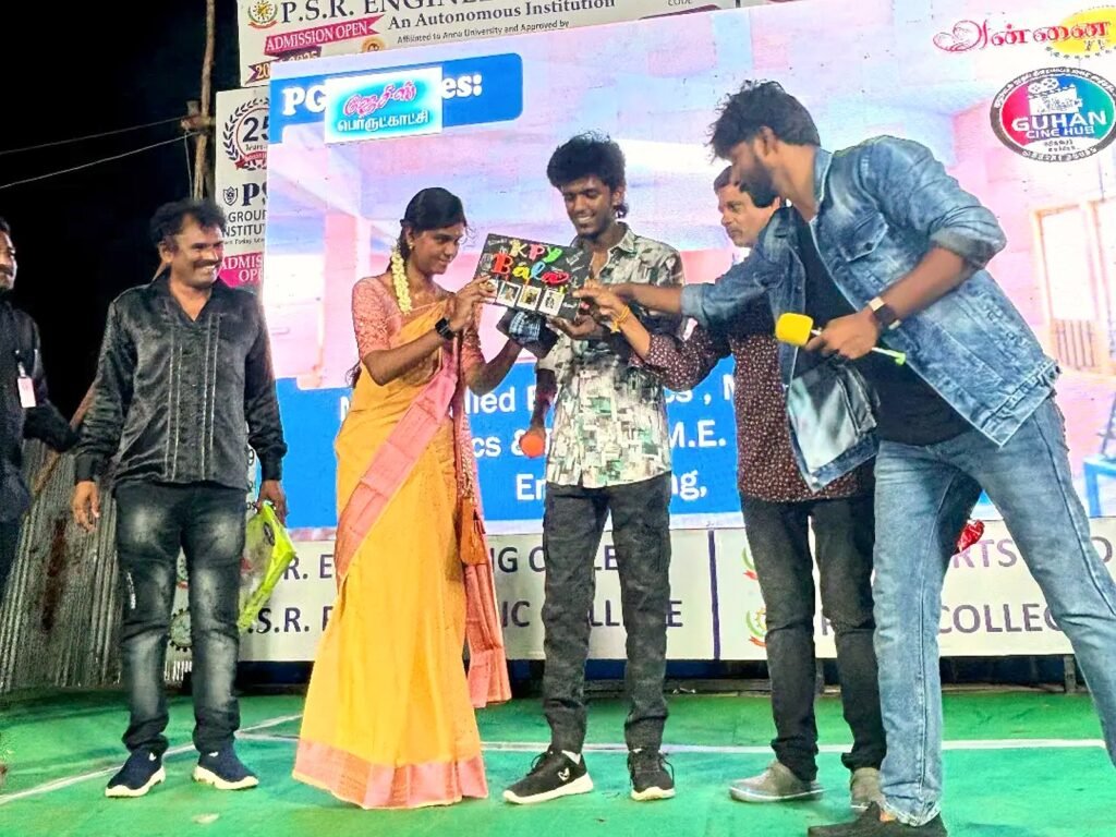 Bhuvi presenting a handmade string art gift to actor KPY Bala of Vijay TV