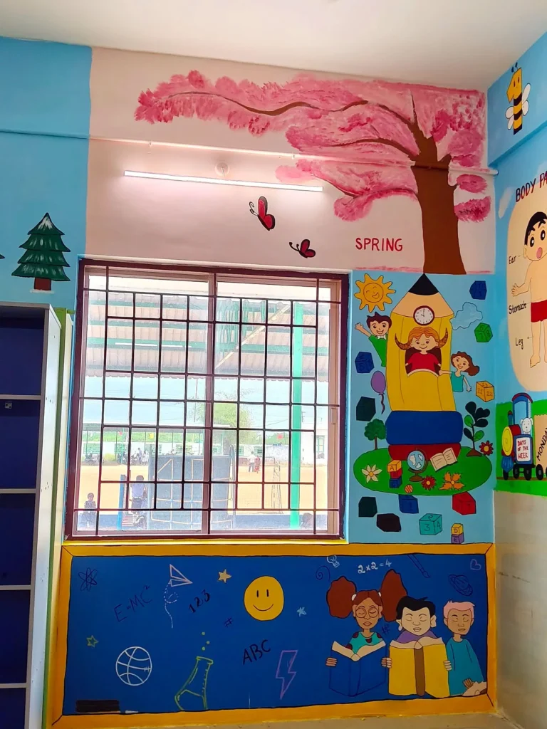 Pink blossom tree and children mural painted around a classroom window — CBSE school wall painting in Sivakasi