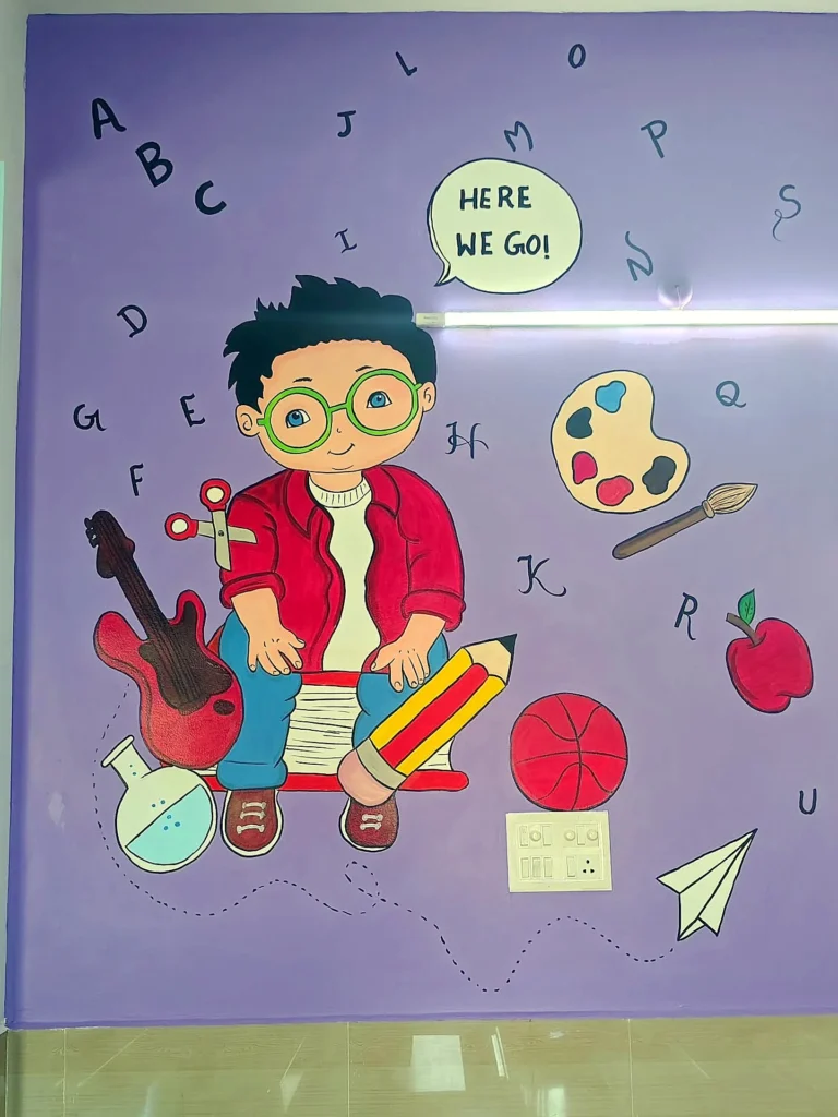 Boy with a guitar and art supplies — KG classroom wall painting at Sri Krishnasamy International School, Sivakasi