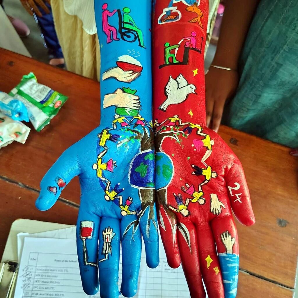 Student hand painting artwork from the competition judged by Bhuvi